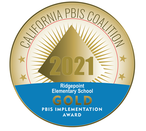 upper 2/3rds of the gold seal that has a inner circle and a part of a diamond shape with lines coming off it, the lower half in blue and says that Ridgepoint received a gold award for PBIS implementation